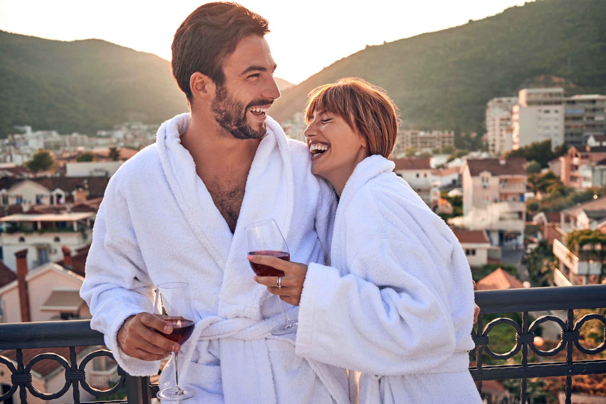 Couple laughing together on a terrace